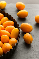 Kumquats on a Plate on a Table