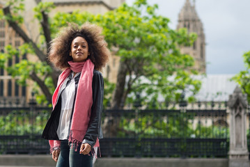 Young woman portrait in the street. Westminster Abbey in the background.