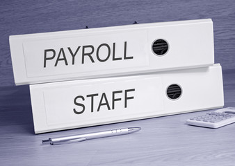 Payroll and Staff - two binders on desk in the office