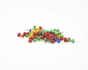 Colorful push pins on white background