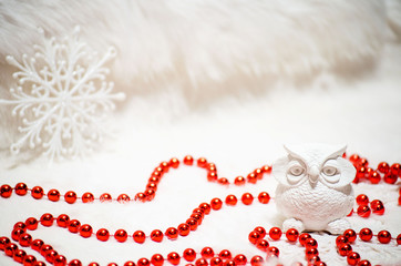 white ceramic owl and red beads in Christmas