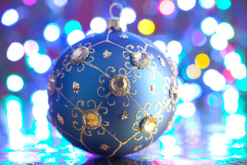 Blue Christmas bauble on lighting background