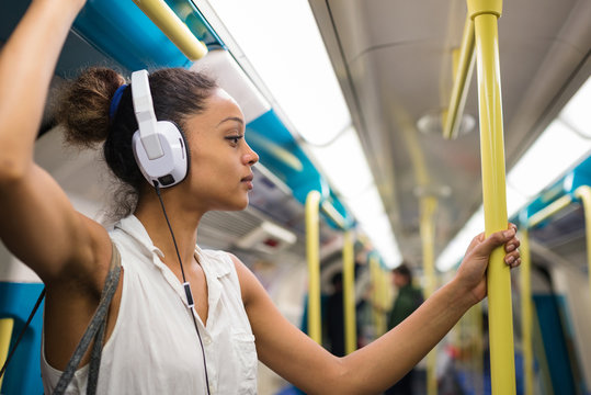 Young Woman Portrait Inside Underground In London Listening To Music.