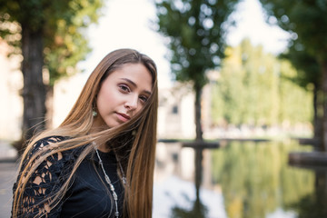 Close up portrait of young blonde woman outdoors. Parma, Italy.