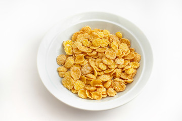 Plate of cornflakes isolated on white background.