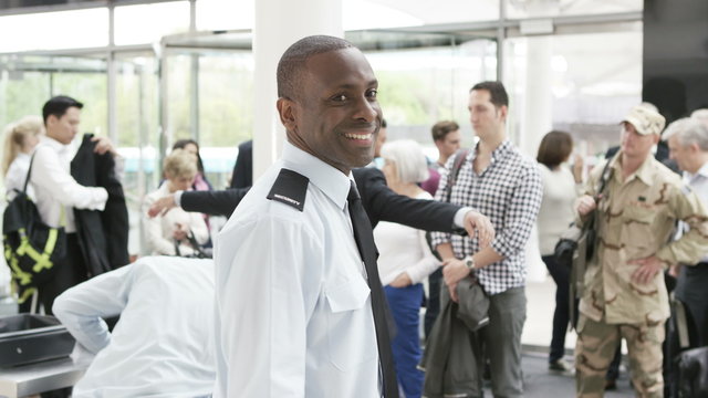  Portrait of smiling airport security guard on duty
