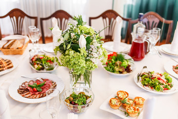 Table served in restaurant with tasty meals.