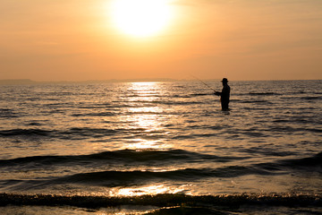 Fototapeta premium Silhouette angler sunset background.