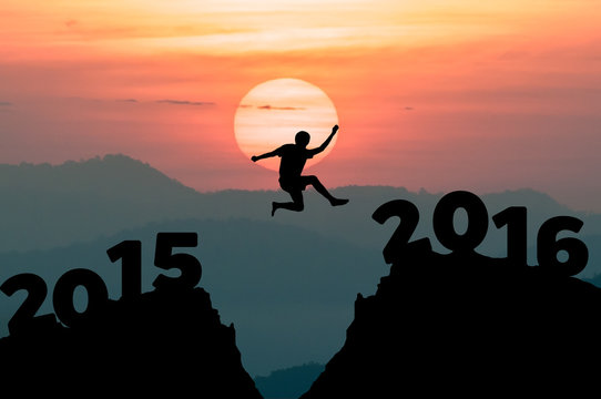 Silhouette man jumps to the New Year 2016 with sunrise
