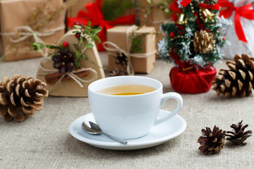 Christmas table with green tea and christmas balls.