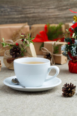 Christmas table with green tea and christmas balls.