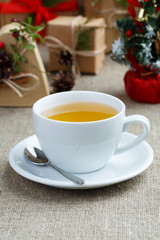 Christmas table with green tea and christmas balls.