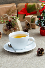 Christmas table with green tea and christmas balls.