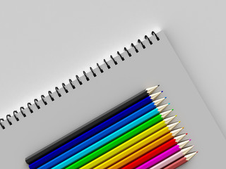 Fototapeta premium notebook with colored pencils on White background