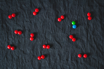 green candy surrounded by red candies