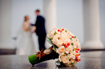 Couple dancing on the background of a beautiful bouquet.