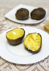 Baked potatoes cut into halves on the table