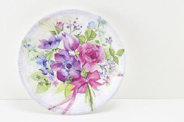 Decoupage decorated plate with flower pattern