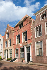 Fototapeta na wymiar Street with row of ancient brickwork mansions, Veere, Netherlands