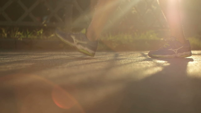 Closeup of woman tying running shoe
