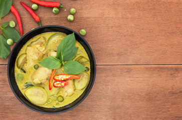 Thai chicken green curry with old wooden background