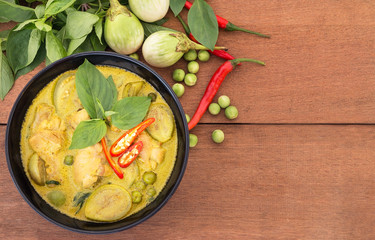 Thai chicken green curry with old wooden background