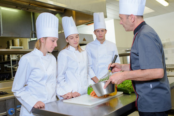 Cooking lesson with three apprentices