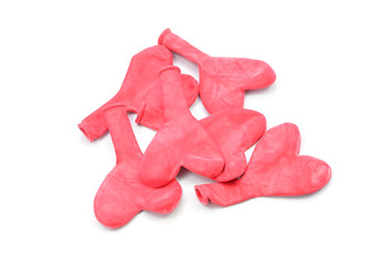 deflated heart-shaped balloons on a white background