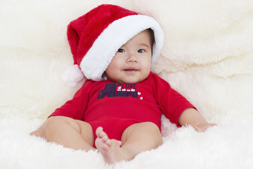 Baby with Santa hat. Merry Christmas and a happy new year with A
