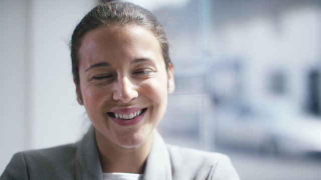 Close-up portrait of a confident business woman smiling into camera