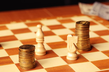 gold coins stacked like a pawn on a chess board