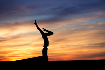 silhouetted gymnast in sunset