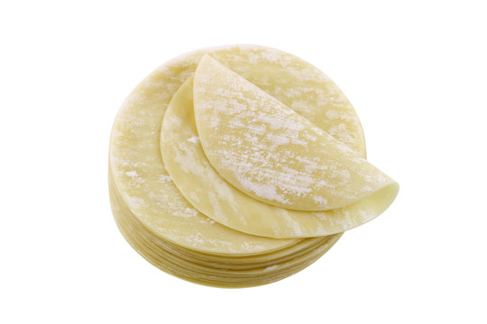 Closeup of fresh dumpling wrappers to make wontons and other Chinese food, isolated on white background