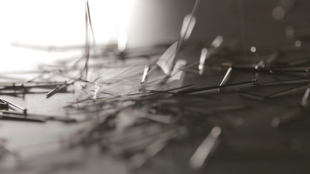 Many pins crashing to floor on dark background in motion. Close up