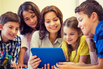 group of kids with teacher and tablet pc at school