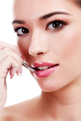 Fototapeta premium Pretty woman with makeup brush, isolated on white