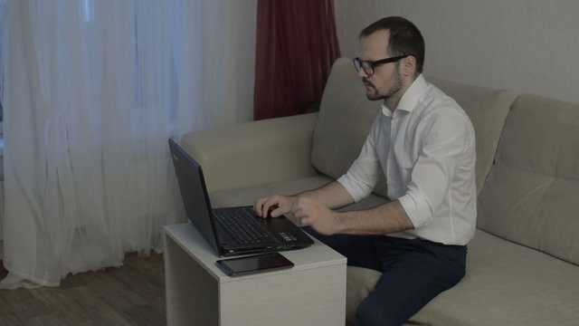 Man working from home with laptop alone