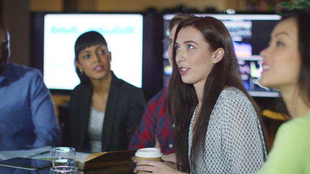  Attractive mixed ethnicity business team asking questions in a meeting