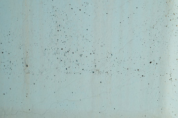 Detail of concrete wall painted in blue color in sunlight