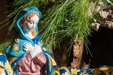Painted pottery statue portraying the virgin Mary in the ceramic nativity scene of an artisan in Caltagirone