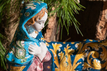 Fototapeta premium Painted pottery statue portraying the virgin Mary in the ceramic nativity scene of an artisan in Caltagirone