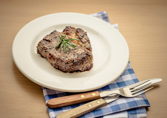 Juicy grilled rib eye steak with cutlery
