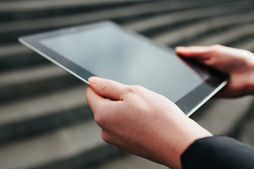 tablet with a blank screen in the hands outside