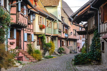 Fototapeta na wymiar Half-timbered houses on a narrow street in Eguisheim, Alsace, France