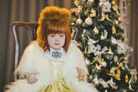 Little Princess in a fur coat around the Christmas tree 4543.