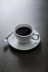 Cup of coffee on wooden  dark table