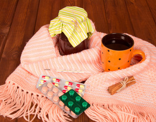 cup of tea, jar with jam and pills closeup
