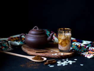 Masala tea set. Table with traditional tea setting. Dark photo, selective focus