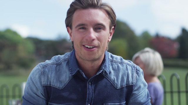  Happy young man having a video chat, as seen from the computer screen's point of view