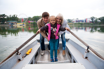 Fototapeta na wymiar Portrait of a nice family on a boat